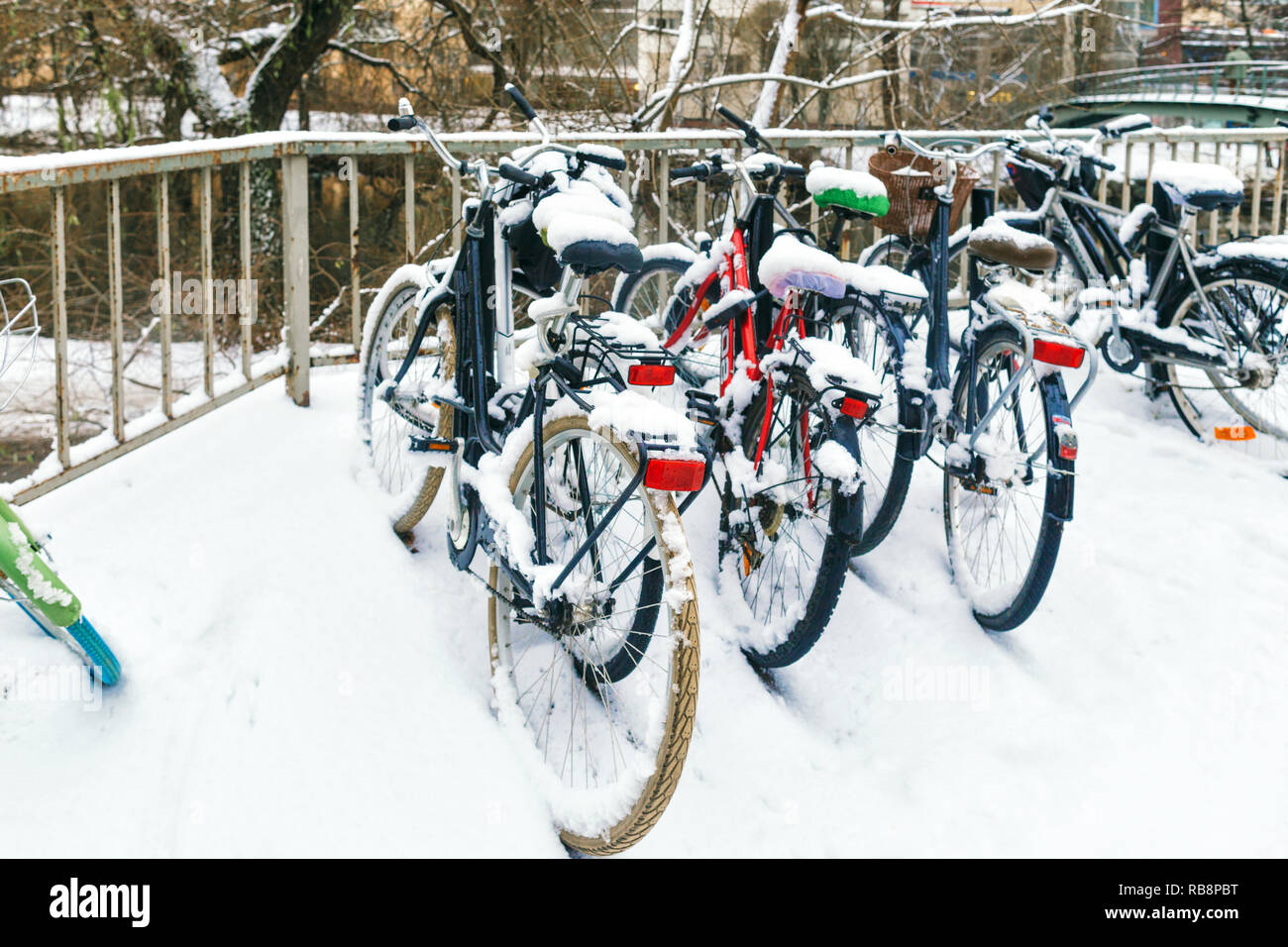 Ecological means of transportation. Environmental protection concept. Stockholm, Sweden. Parked bicycles in the snow Stock Photo