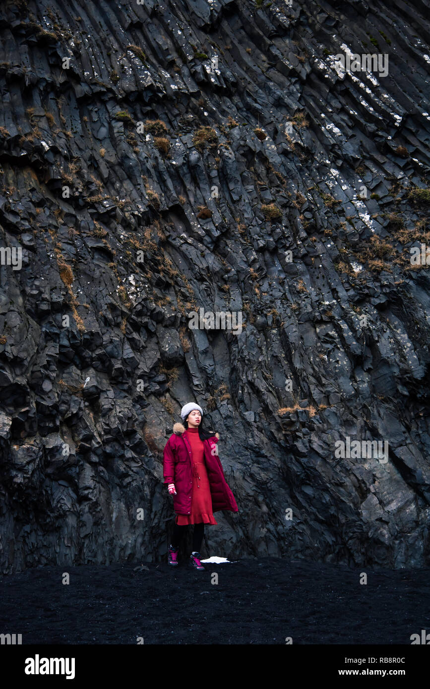 Traveler exploring famous Black sand Reynisfjara Beach in Iceland Stock Photo