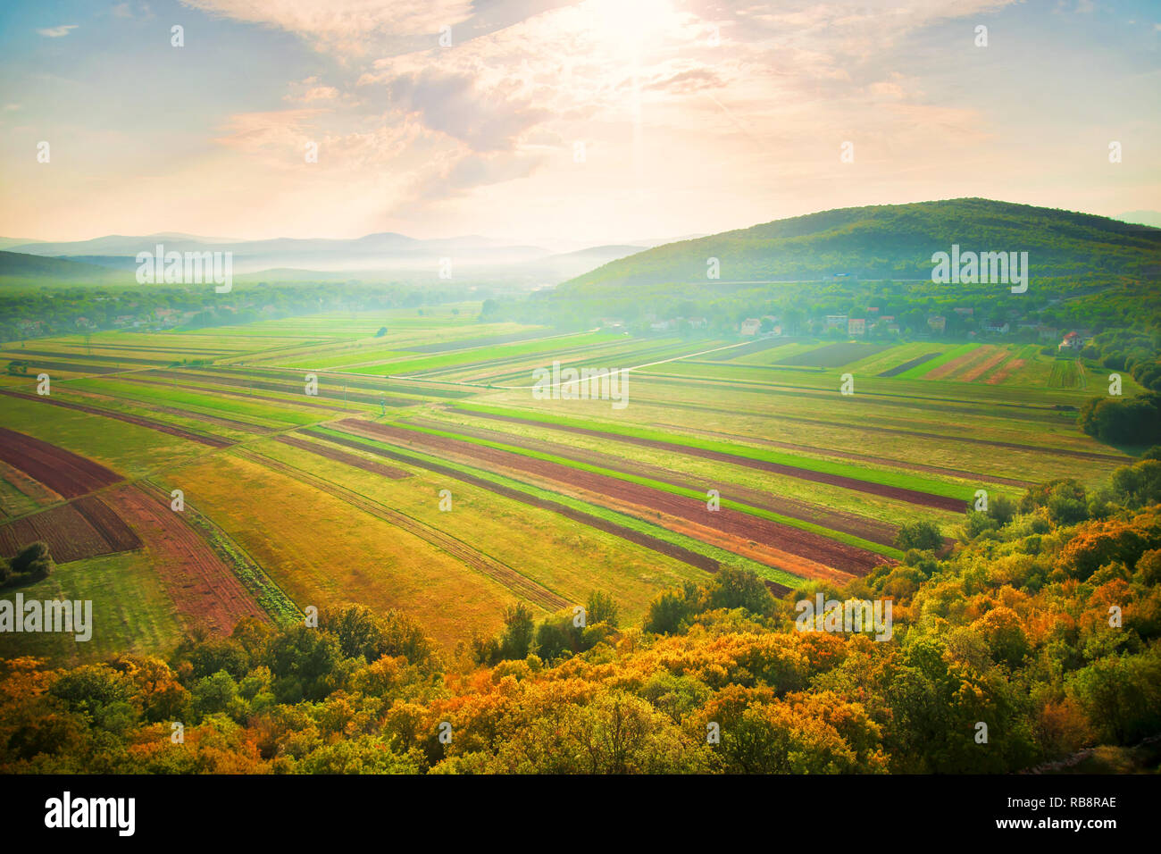 top view of agricultural fields with mountains at background on sunny autumn morning Stock Photo