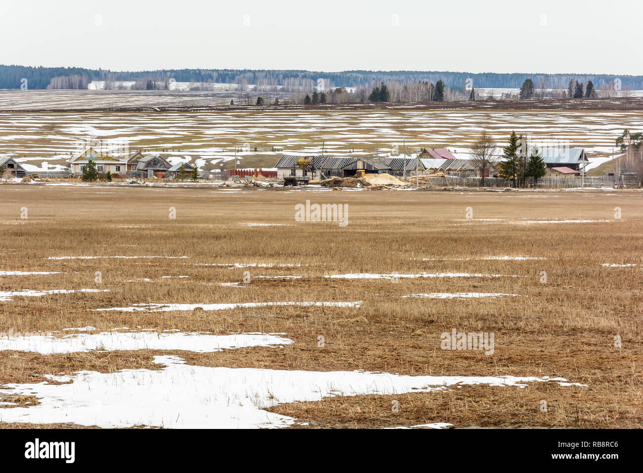 The melting of the snow on the fields in early spring Stock Photo