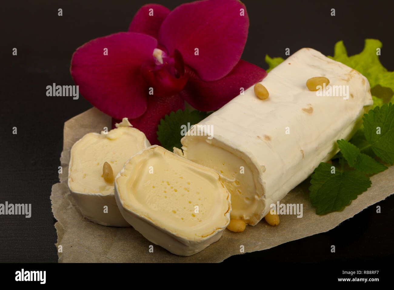 Brie cheese roll with cedar nuts Stock Photo Alamy