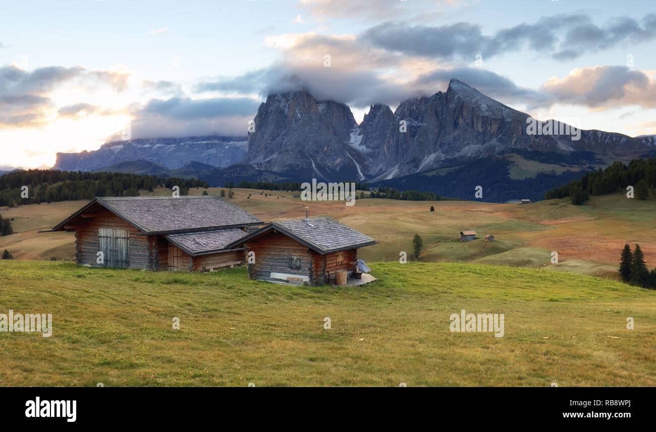 Beautiful Scenery from Alpe di Siusi, Italy in summer sunrise light with small wooden cottage and sharp mountains of dolomite. Seiser Alm with Langkof Stock Photo