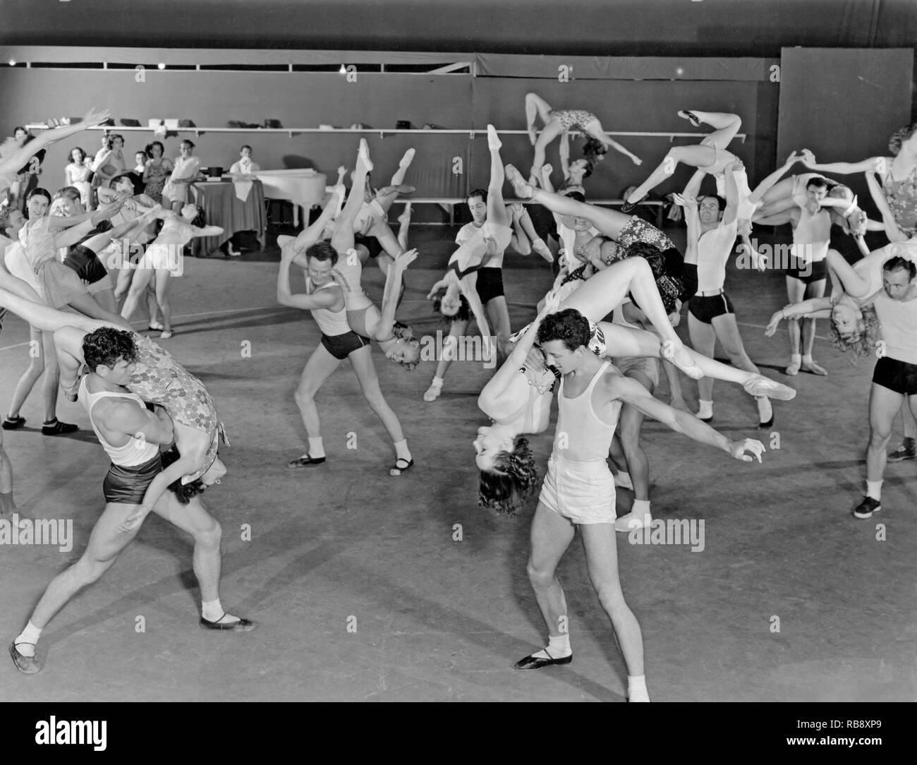 Dancers in the 1930s. A group of well-trained dancers are rehersing for a new Metro-Goldwyn-Mayer film. They are part of a choreography by Albertina Rasch. Stock Photo