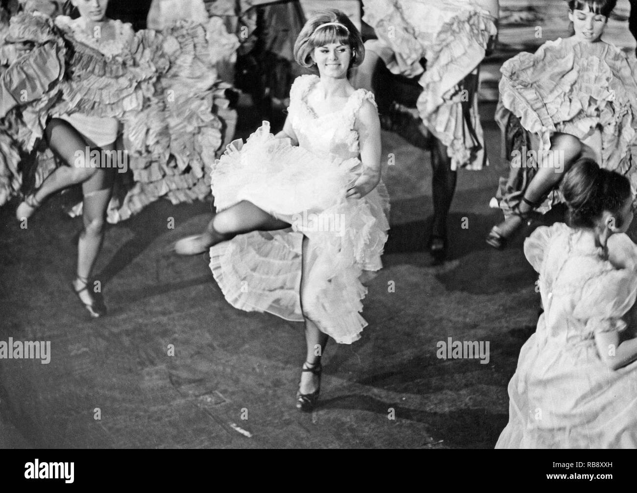 The Can-Can dance. A high-energy, physically demanding dance that became a popular music hall dance in the 1840s, continuing in popularity in French cabaret to this day. The main features of the dance are the vigorous manipulation of skirts and petticoats, along with high kicks, splits and cartwheels. Pictured woman dancing the Can-Can 1966. Sweden Stock Photo