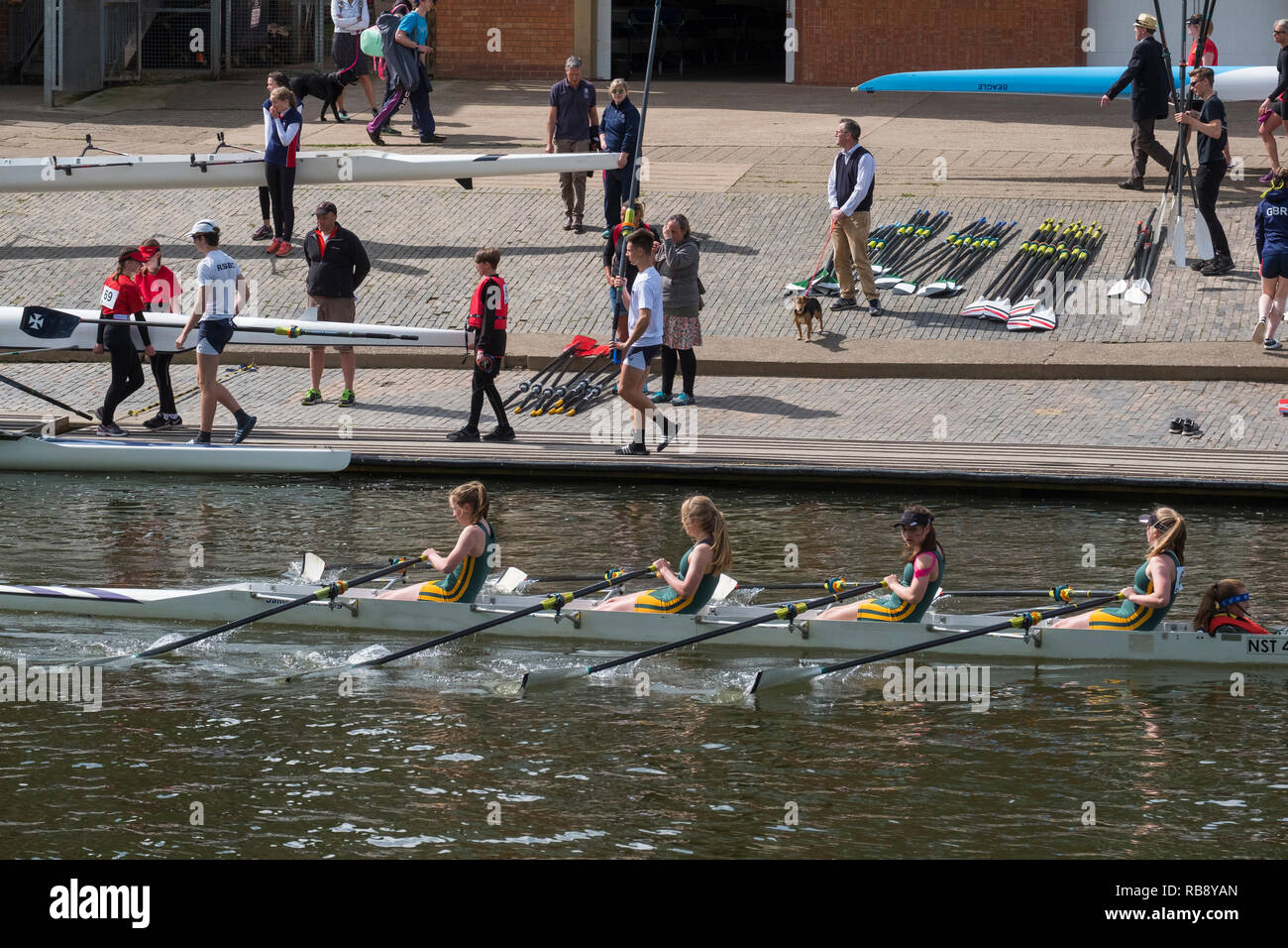 A female rowing crew passing other competitors at Shrewsbury Regatta on