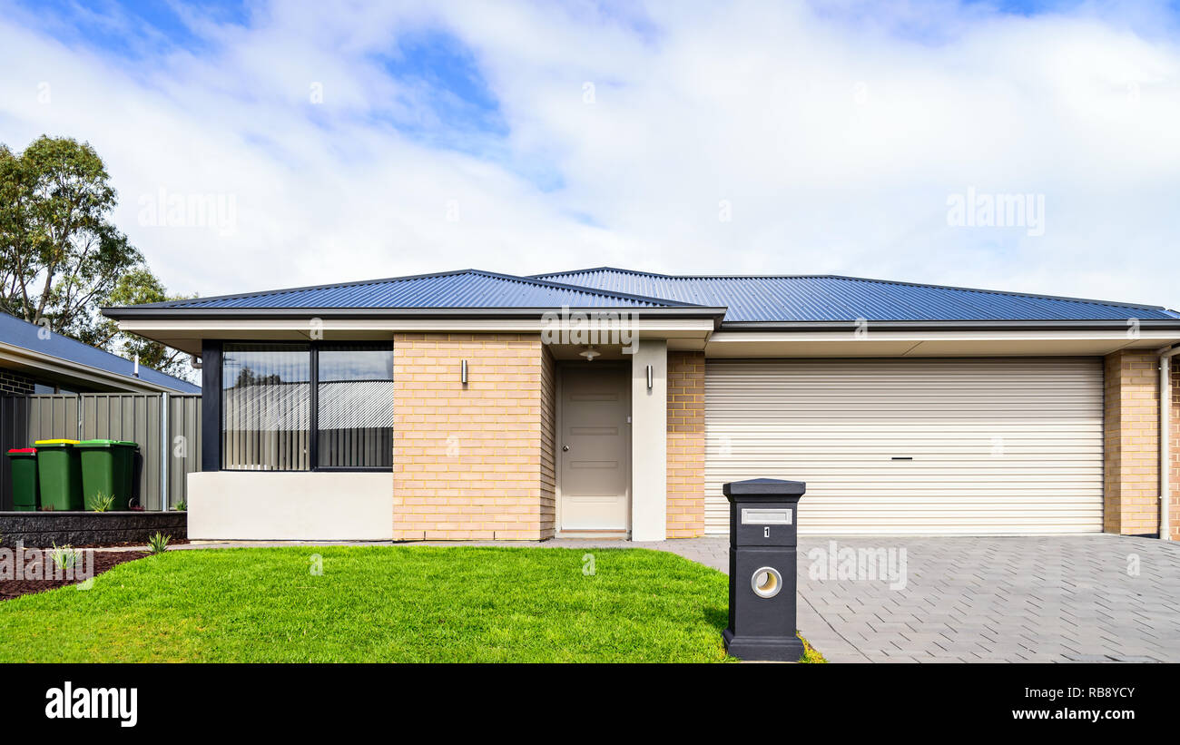 Brand new Australian median house with double garage door, landscaping and mailbox at front Stock Photo