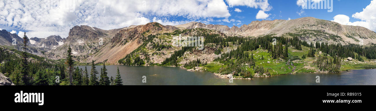 Majestic panorama view of a tranquil lake surrounded by trees in a Colorado Rocky Mountains landscape Stock Photo