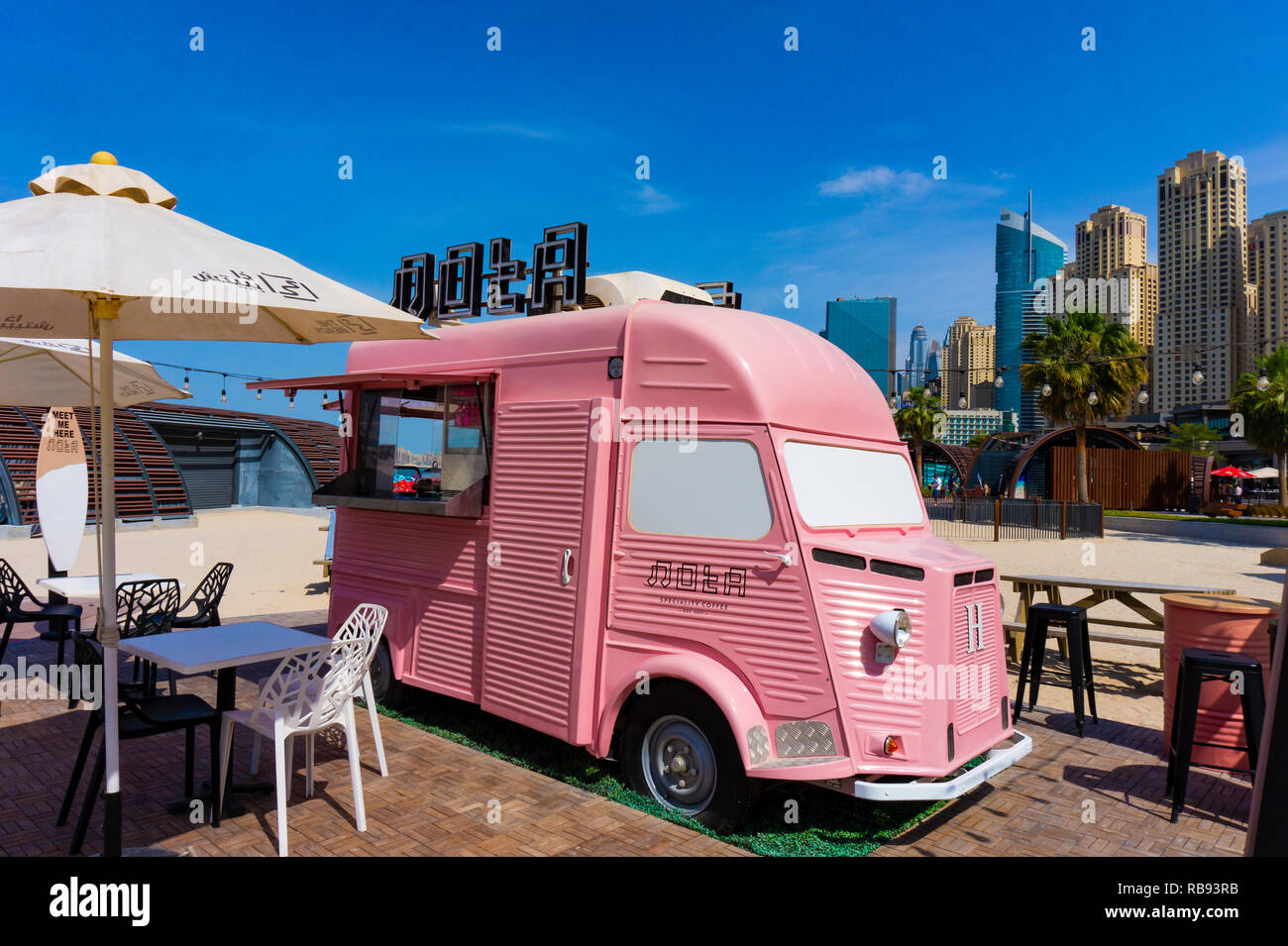 Dubai,UAE 10.31.2018 : Pink retro Note food caffee truck bus with skyscrapers in the background Stock Photo