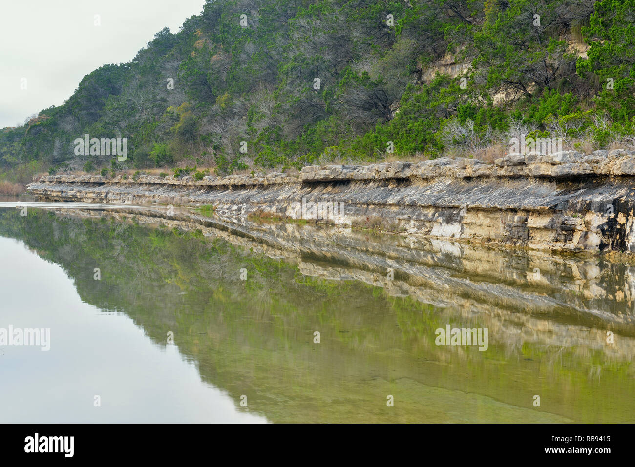 Shoreline rocks reflected in Cow Creek, Balcones Canyonlands National Wildlife Refuge, Texas, USA Stock Photo