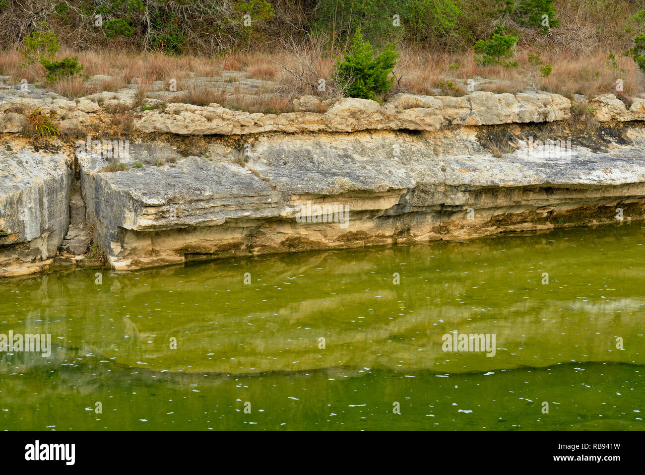 Shoreline rocks reflected in Cow Creek, Balcones Canyonlands National Wildlife Refuge, Texas, USA Stock Photo