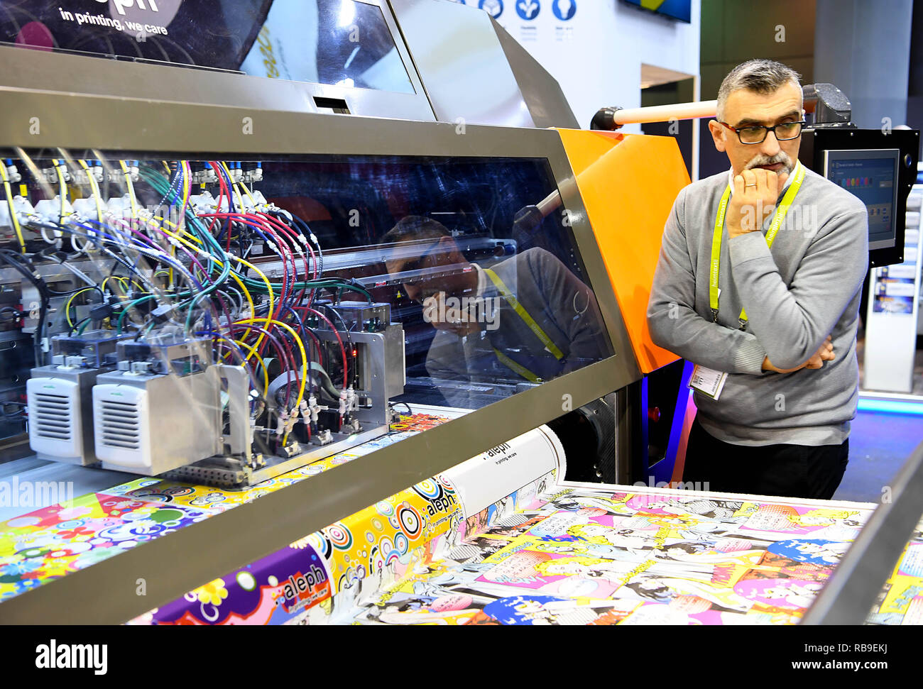 Frankfurt, Germany. 8th Jan, 2019. An exhibitor stands next to a digital printer for textiles during Heimtextil in Frankfurt, Germany, on Jan. 8, 2019. The World's largest international trade fair for home and contract textiles, namely Heimtextil, kicked off Tuesday in Frankfurt. Credit: Lu Yang/Xinhua/Alamy Live News Stock Photo