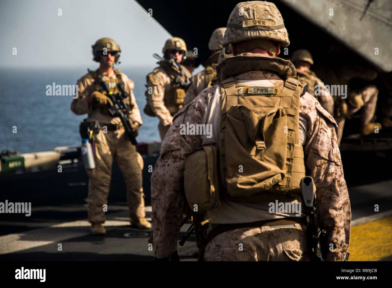 ARABIAN SEA - U.S. Marines and Sailors with Lima Company, Battalion Landing Team 3/1, 13th Marine Expeditionary Unit (MEU), board a CH-53E Super Stallion during a Tactical Recovery of Aircraft Personnel training exercise aboard the Wasp-class amphibious assault ship USS Essex (LHD 2), Jan. 05, 2019. The Essex is the flagship for the Essex Amphibious Ready Group and, with the embarked 13th MEU, is deployed to the U.S. Fifth Fleet area of operations in support of naval operations to ensure maritime stability and security in the Central Region, connecting the Mediterranean and the Pacific through Stock Photo
