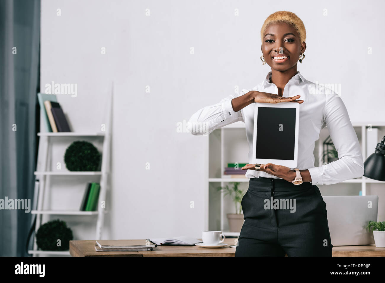 happy african american woman showing digital tablet with blank screen ...