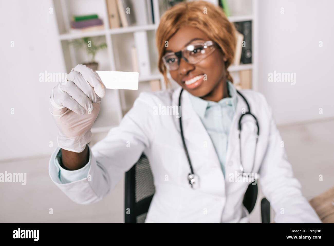 selective focus of sample in hand of female african american scientist ...