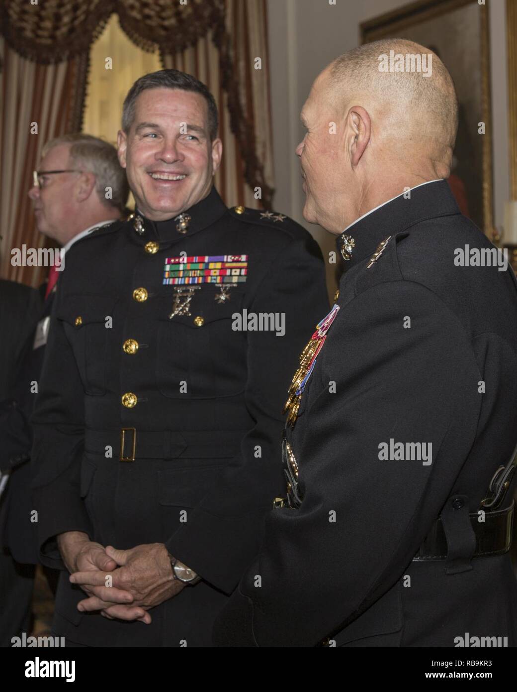 Commandant of the Marine Corps Gen. Robert B. Neller, right, speaks with Maj. Gen. John R. Ewers, Jr., staff judge advocate to the Commandant, before the 2017 Surprise Serenade at the Home of the Commandants, Washington, D.C., Jan. 1, 2017. The Surprise Serenade is a tradition that dates back to the mid-1800’s in which the U.S. Marine Band performs music for the Commandant of the Marine Corps at his home on New Years Day. Stock Photo