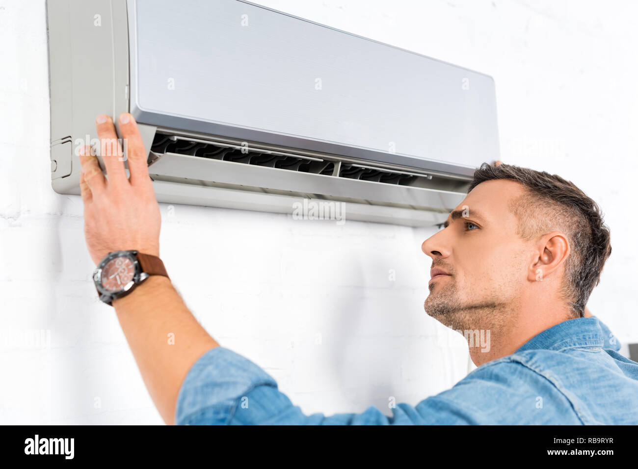 Man Using Ac Handsome man air conditioner hi-res stock photography and images - Alamy