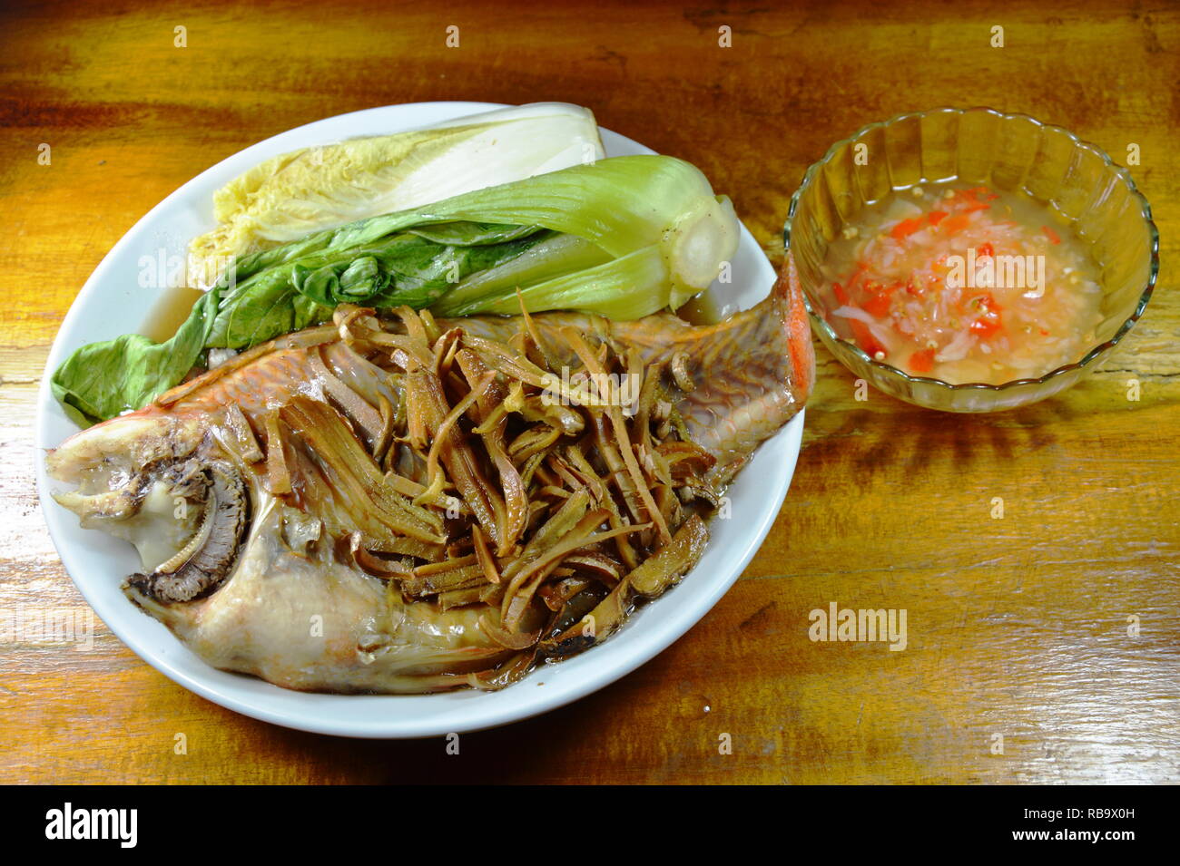 steamed red mango fish with vegetable topping slice ginger dipping ...