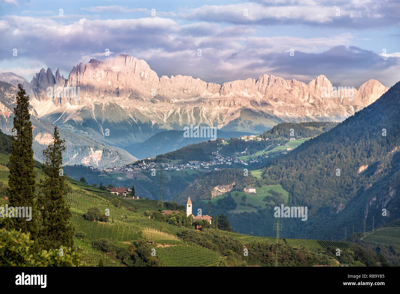 A view to the Rosengarten (in Italian Catinaccio) group in the Dolomites, part of the Alps. Clouds casting shadows. Stock Photo