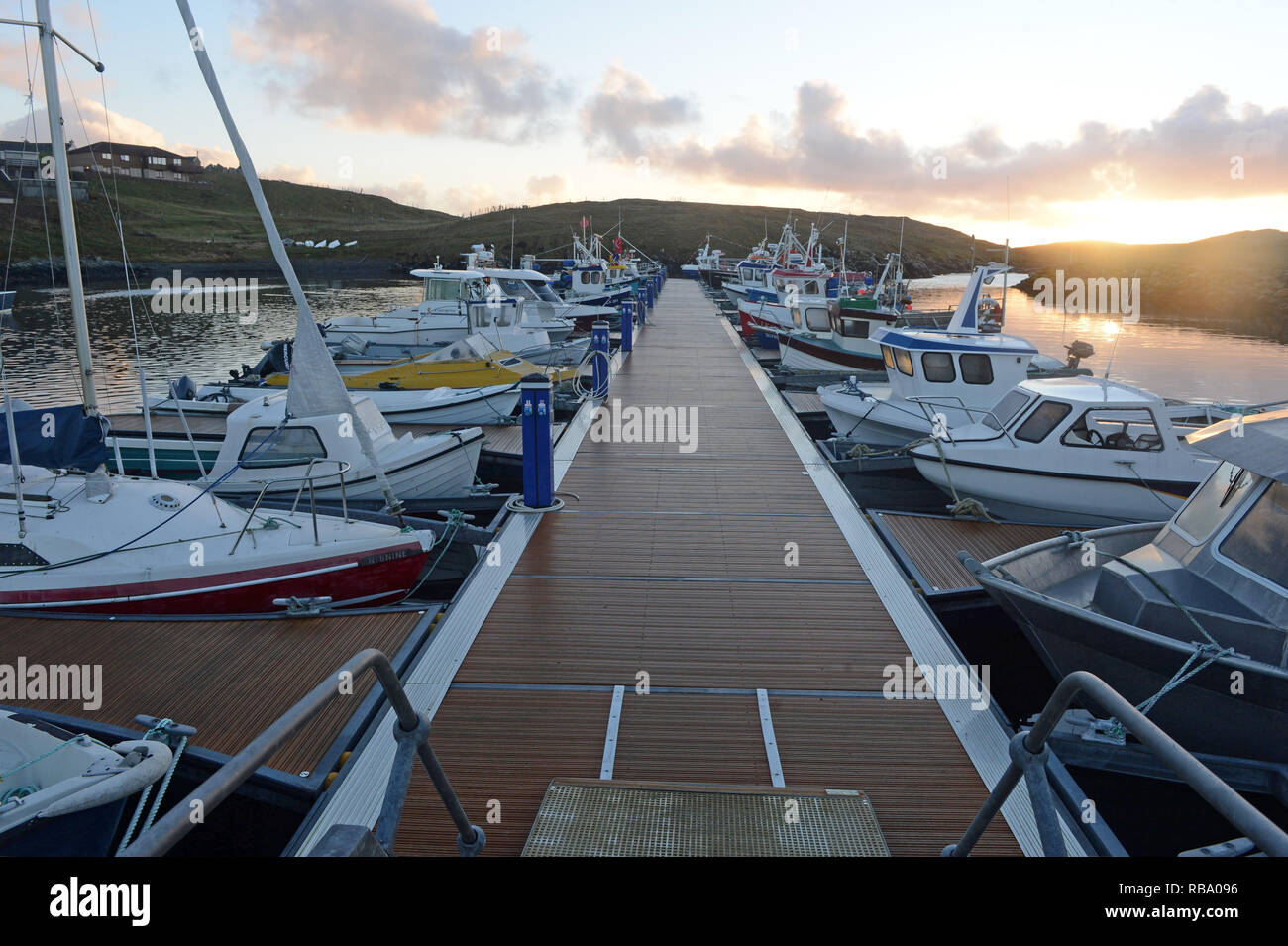 Hamnavoe boat harbour marina on a sunny morning on the island of Burra in the Shetland Islands