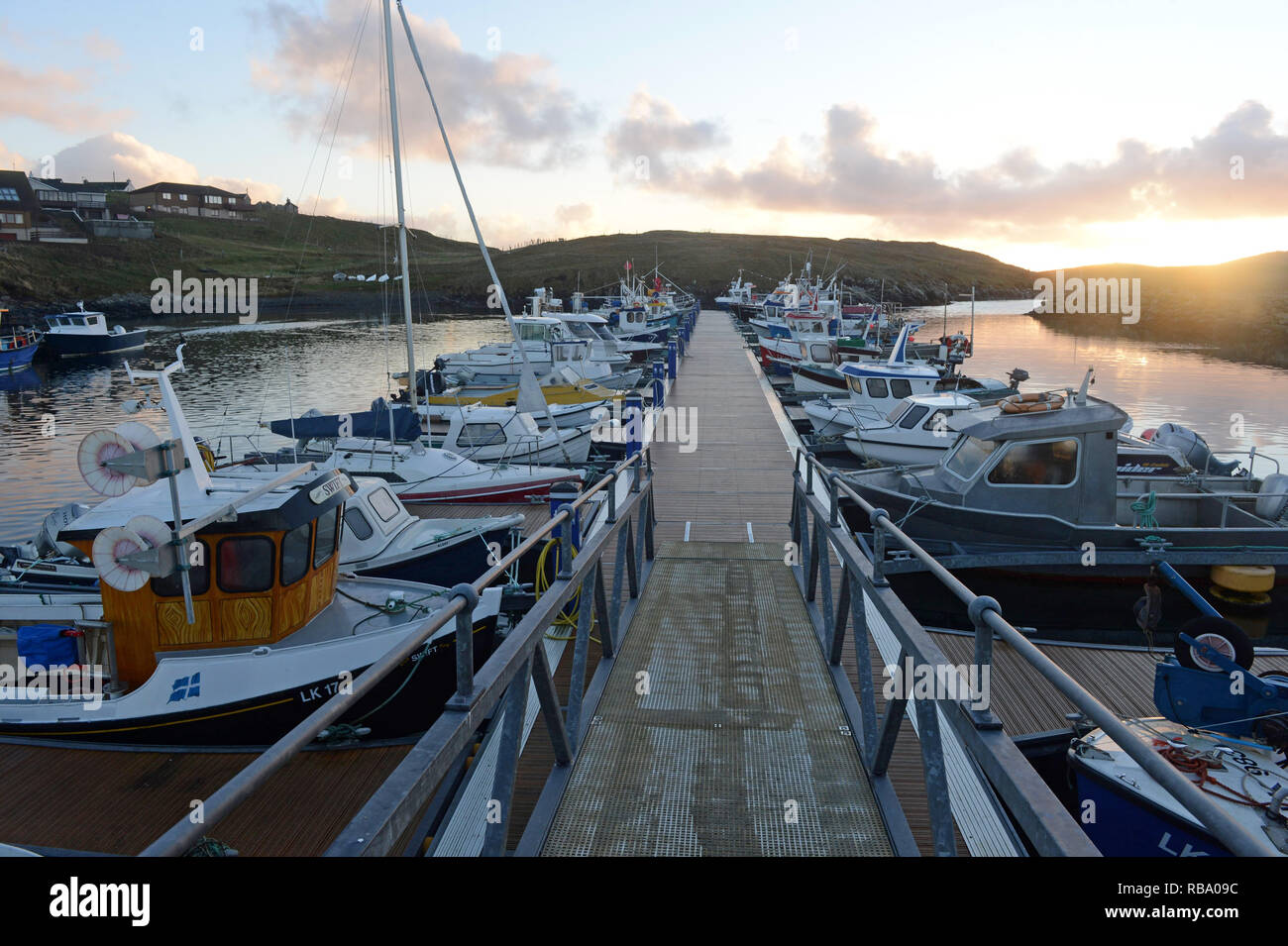 Hamnavoe boat harbour marina on a sunny morning on the island of Burra in the Shetland Islands