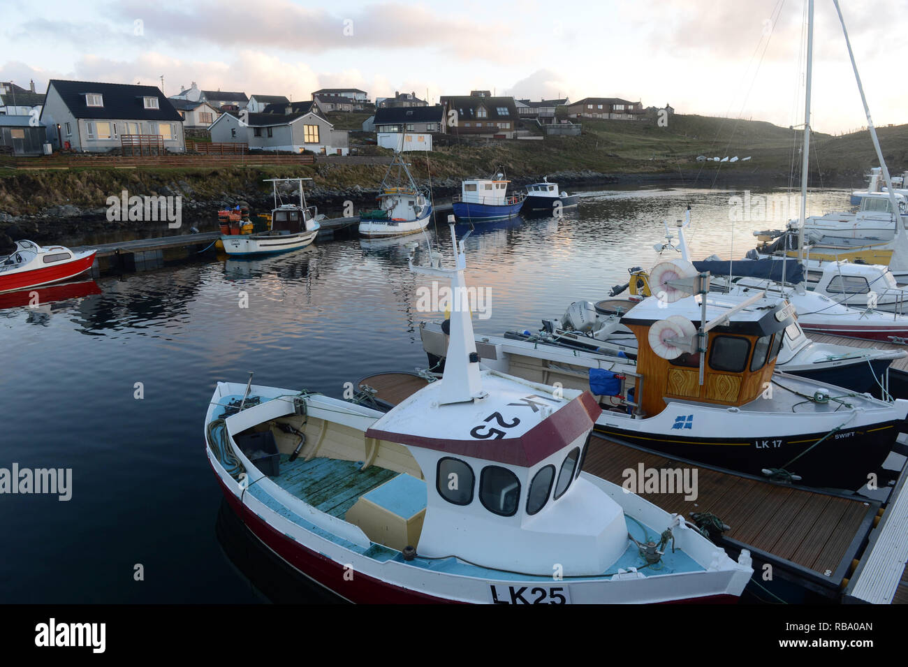 Hamnavoe boat harbour marina on a sunny morning on the island of Burra in the Shetland Islands