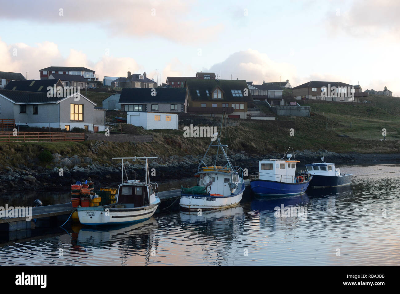 Hamnavoe boat harbour marina on a sunny morning on the island of Burra in the Shetland Islands