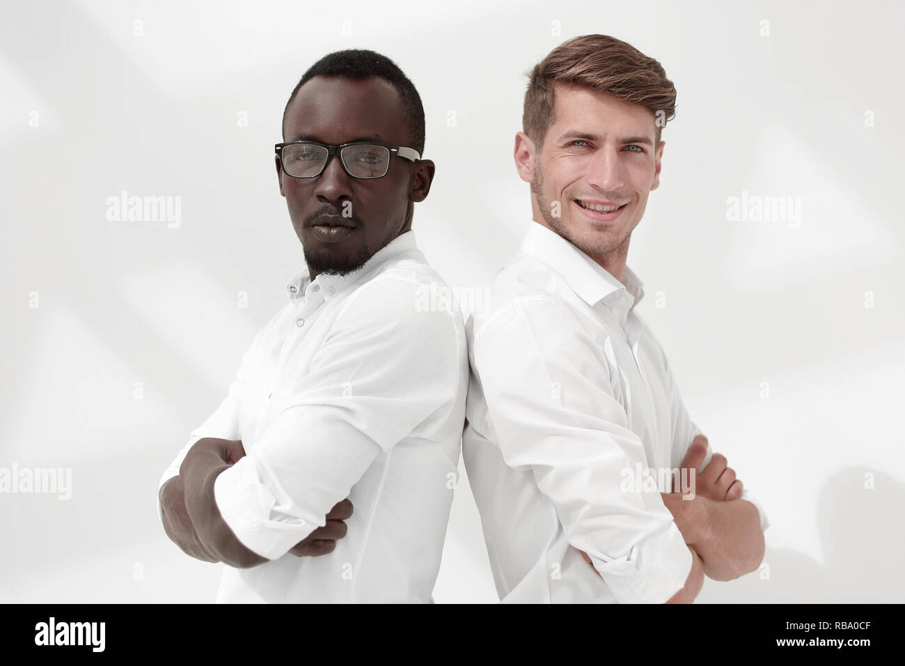 two young business partners standing back to back Stock Photo - Alamy