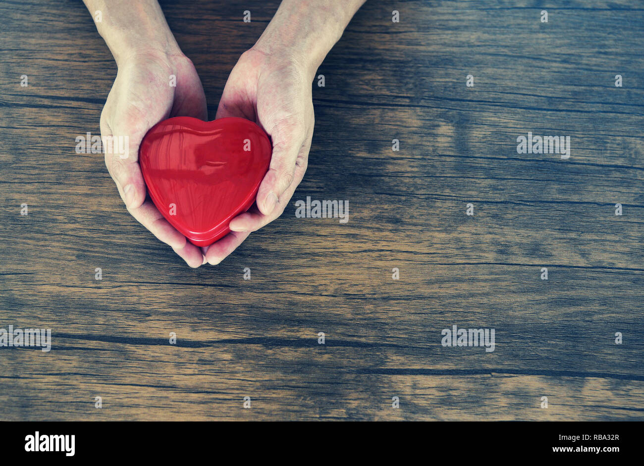 Give Love Man Holding Red Heart In Hands For Love Valentines Day Donate Help Give Love Warmth Take Care Concept On Wooden Table Rustic Background Stock Photo Alamy