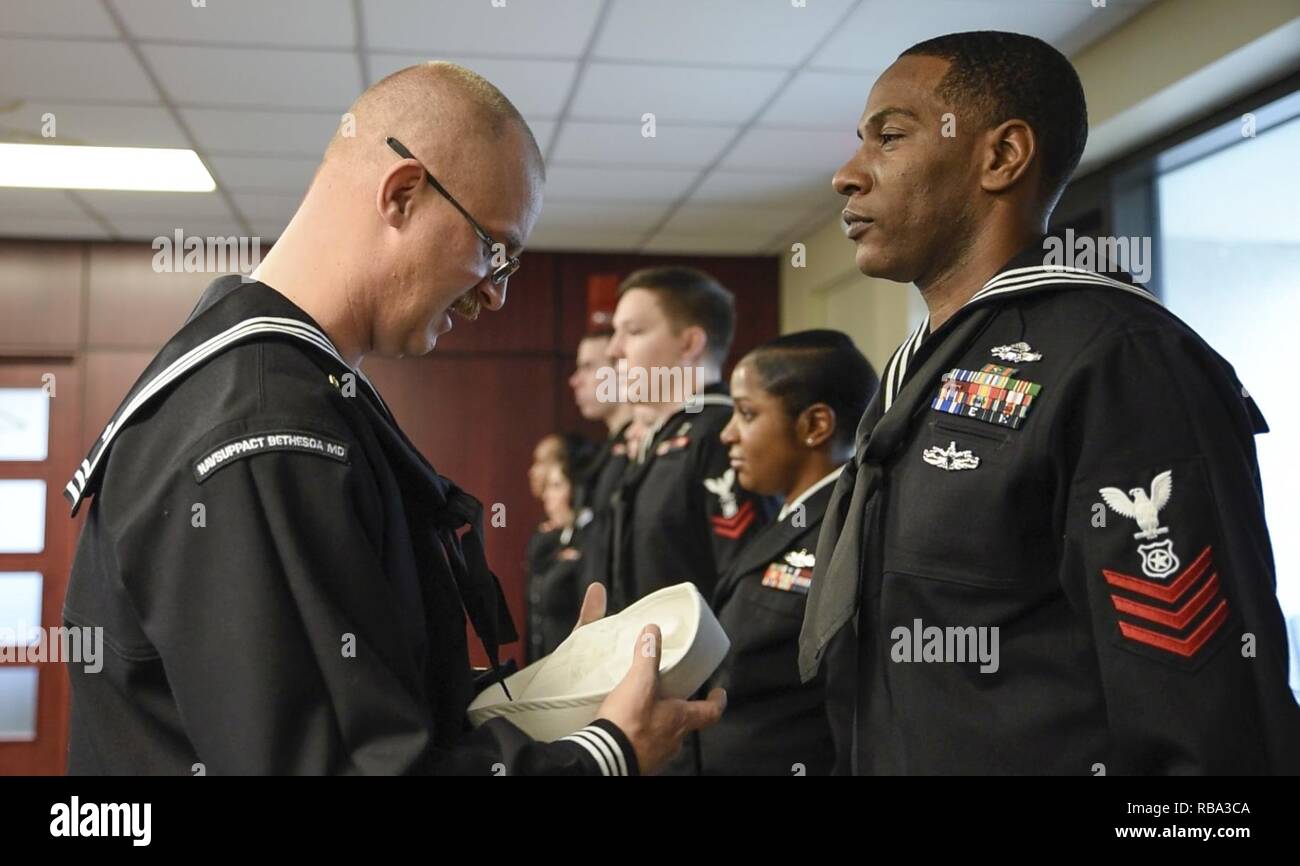 Bethesda, Md.) Master-at-Arms 1st Class Michael Olivieri, Naval Support Activity Bethesda (NSAB) security department operations leading petty officer, inspects Master-at-Arms 1st Class Michael Jackson's, training leading petty officer at NSAB, dress blue