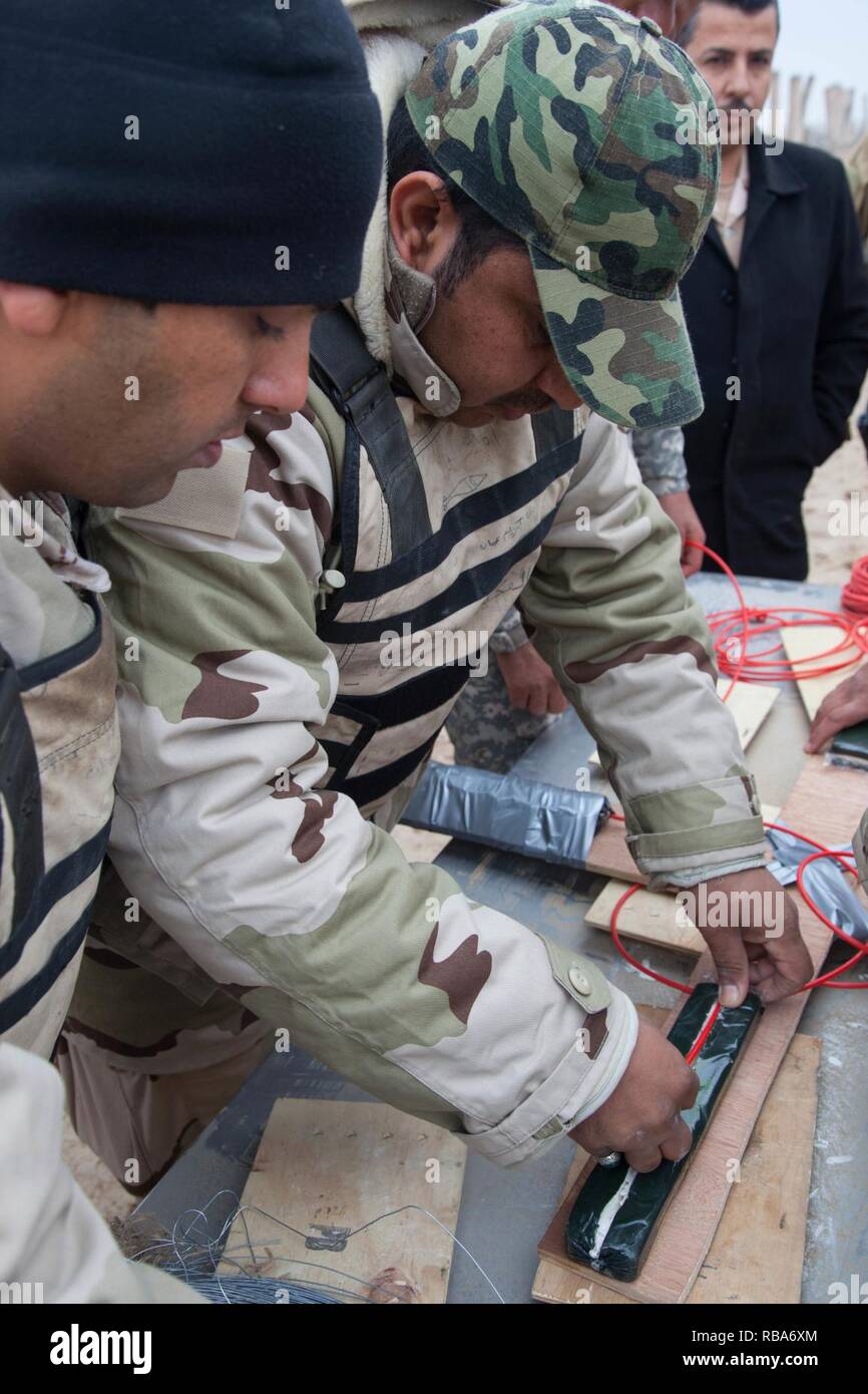 Iraqi security forces soldiers build a shaped explosive charge used to breach walls during training at Besmaya Range Complex, Iraq, Dec. 27, 2016. This training was conducted as part of Combined Joint Task Force-Operation Inherent Resolve is the global Coalition to defeat ISIL in Iraq and Syria. Stock Photo