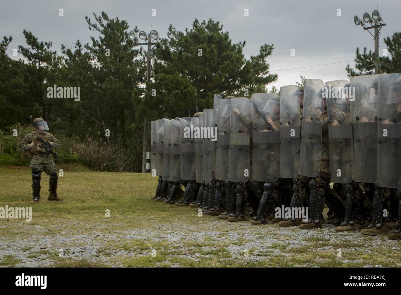 Marines with Echo Battery, Battalion Landing Team, 2nd Battalion, 5th Marines, 31st Marine Expeditionary Unit and military police with Combat Logistics Battalion 31, 31st MEU, conduct non-lethal weapons training at Camp Hansen, Okinawa, Japan, Dec. 29, 2016. Echo Battery and Military Police Platoon trained with modified weapons to reinforce crowd and riot control tactics using non-lethal munitions. As the Marine Corps' only continuously forward-deployed unit, the 31st MEU air-ground-logistics team provides a flexible force, ready to perform a wide range of military operations, from limited com Stock Photo