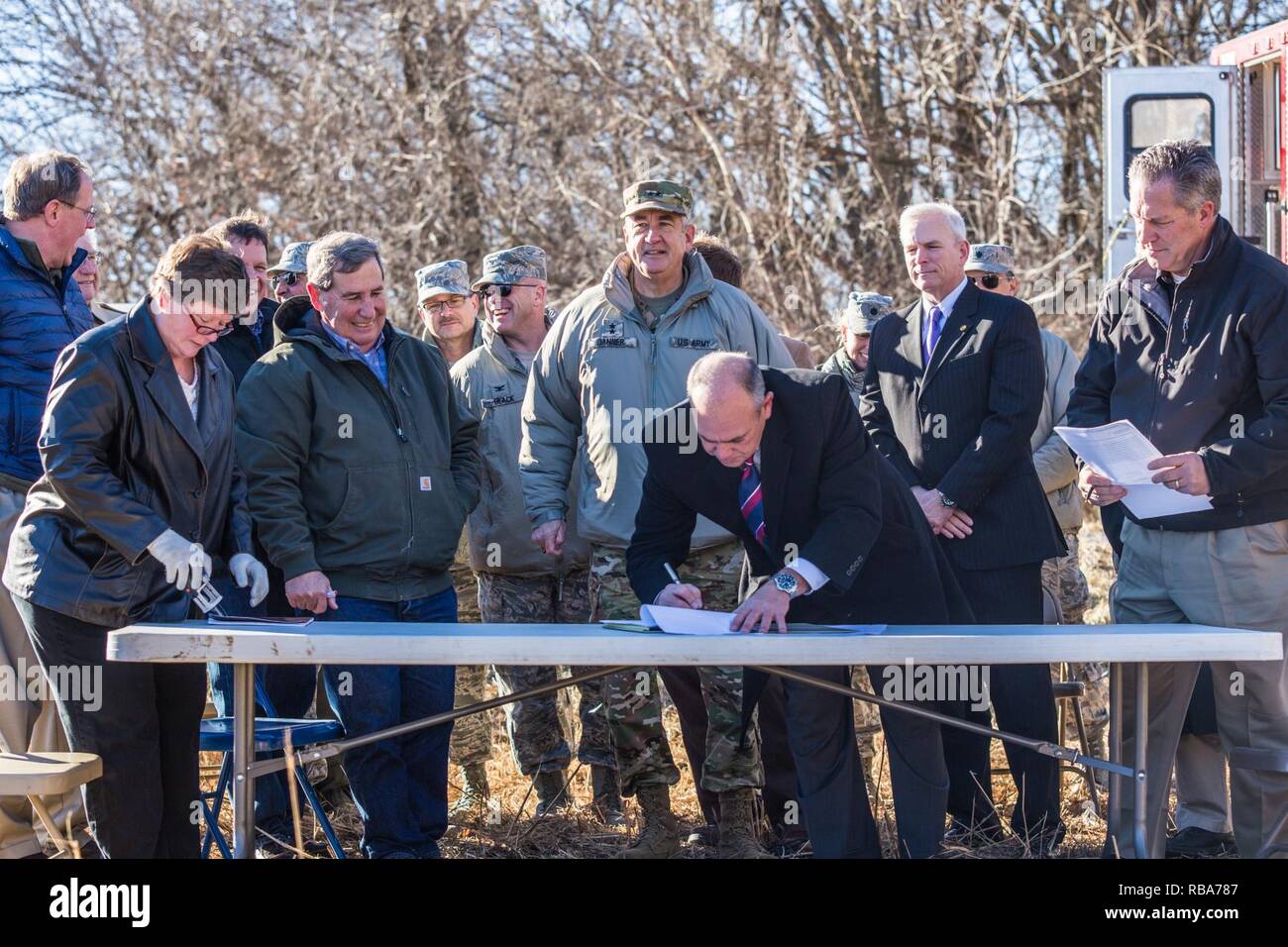 Harry Roberts, county commissioner of Buchanan County, signs paperwork during a ribbon cutting ceremony for a new training site for northwest Missouri, in St. Joseph, Mo., Dec 29, 2016. Buchanan County transferred land to the Missouri National Guard for use as a training site for around 2,000 army units in the northwest Missouri area. Stock Photo