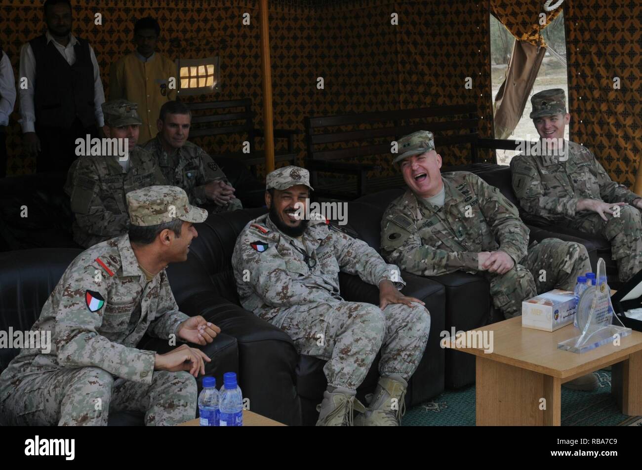 Maj. Gen. Blake Ortner, right, shares a laugh with Col. Jabar Al-boti of the Kuwaiti Air Defense Force during Patriot Day activities at the Kuwaiti Air Defense Force Headquarters December 28, 2016. The friendly competition between the Kuwaitis and the 69th Air Defense Artillery Brigade included events such as setting up an MIM-104 Patriot weapons system, a soccer game, and tug-of-war. ( Stock Photo