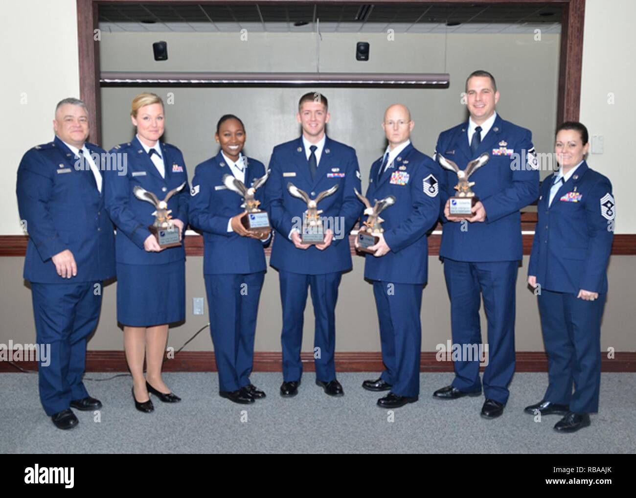 Col. Ken Eaves, 131st Bomb Wing Commander (left) and 131st Command Chief Master Sgt. Jessica Settle (right) recognize winners of the wing’s 2016 Outstanding Airman of the Year awards during the Missouri Air National Guard’s OAY Banquet held at Whiteman Air Force Base, Missouri, Jan. 6. From left to right, winners are: Capt. Amy Cottrell, 131st Medical Group, Company Grade Officer of the Year; Staff Sgt. Heather Campbell, 157th Air Communications Squadron, Noncommissioned Officer of the Year; Senior Airman Travis Hugh, 157th ACOMS, Airman of the Year; Master Sgt. Thomas DuMont Jr., 157th Combat Stock Photo