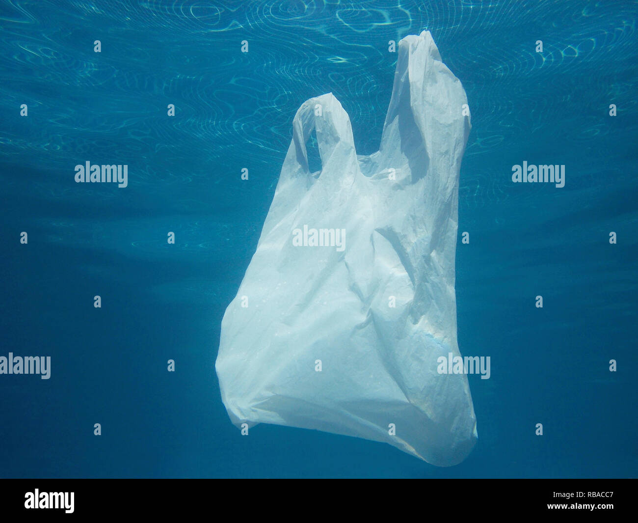 Plastic bag floating into the water. Polluted enviromental. Recycle