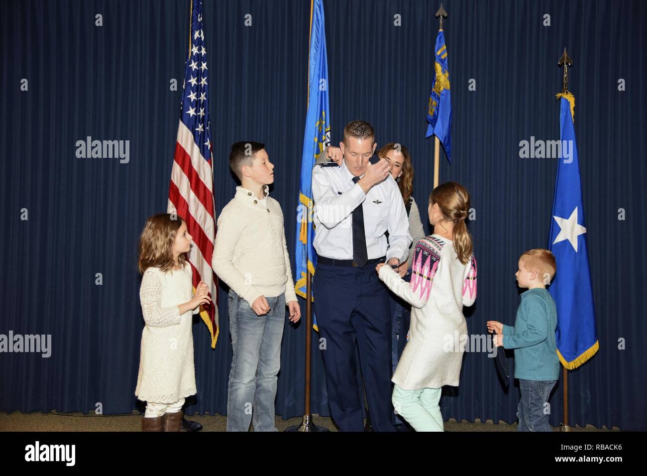 Col. Quenten M. Esser, 114th Operations Group commander, is assisted by his wife, Jennifer, and children, Bryson, Ellie, Paige, and Tate, in pinning on his new rank during his promotion ceremony Jan. 8, 2017 at Joe Foss Field, S.D. Esser assumed command of the 114th Operations Group from Col. Gregory Lair on May 1, 2016. Stock Photo