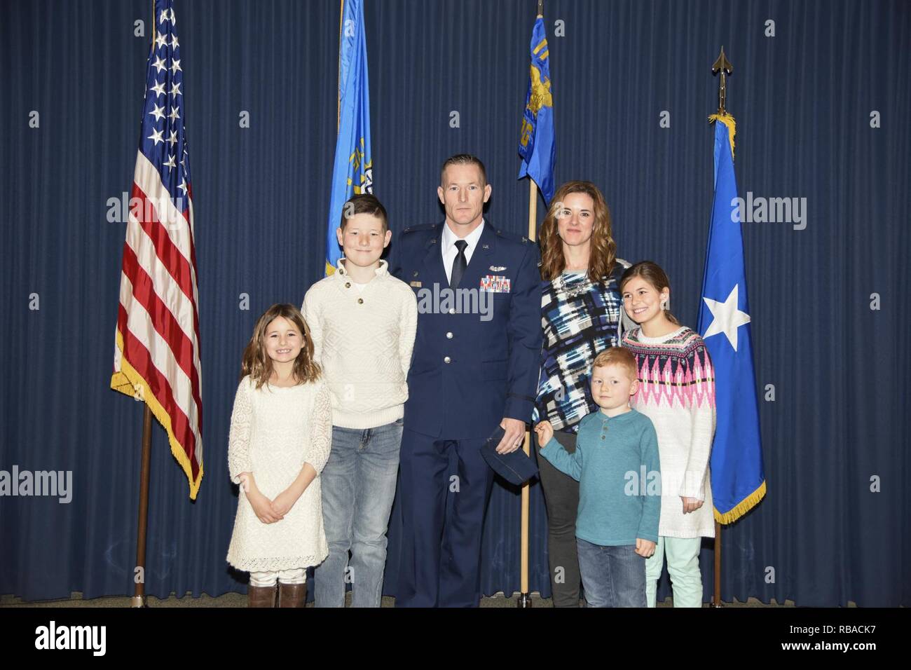 Col. Quenten M. Esser, 114th Operations Group commander,stands next to his wife, Jennifer, and children, Bryson, Ellie, Paige, and Tate, during his promotion ceremony Jan. 8, 2017 at Joe Foss Field, S.D. Esser assumed command of the 114th Operations Group from Col. Gregory Lair on May 1, 2016. Stock Photo