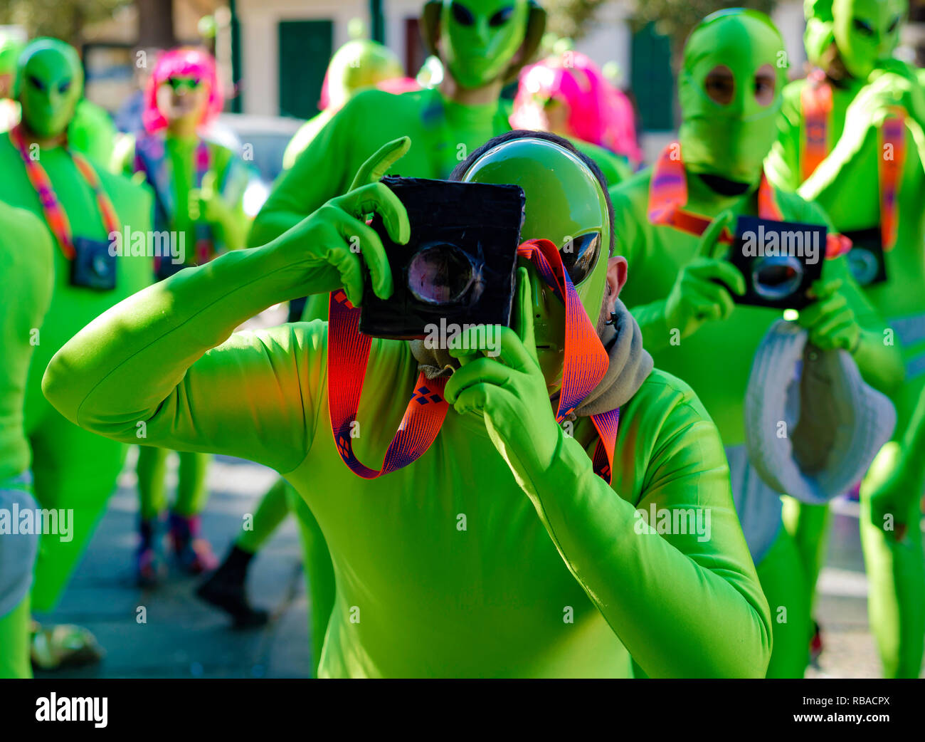 Masked young man with fake camera, beautiful and colorful clothes