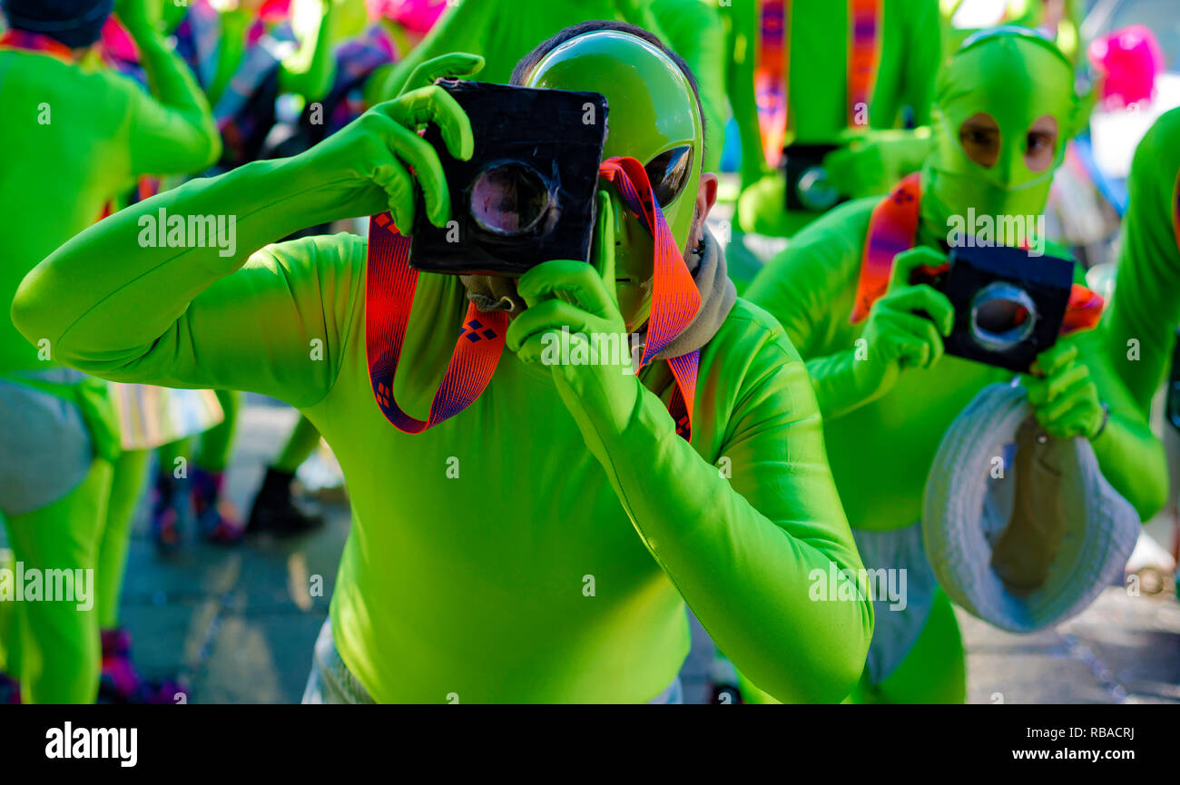 Masked young man with fake camera, beautiful and colorful clothes