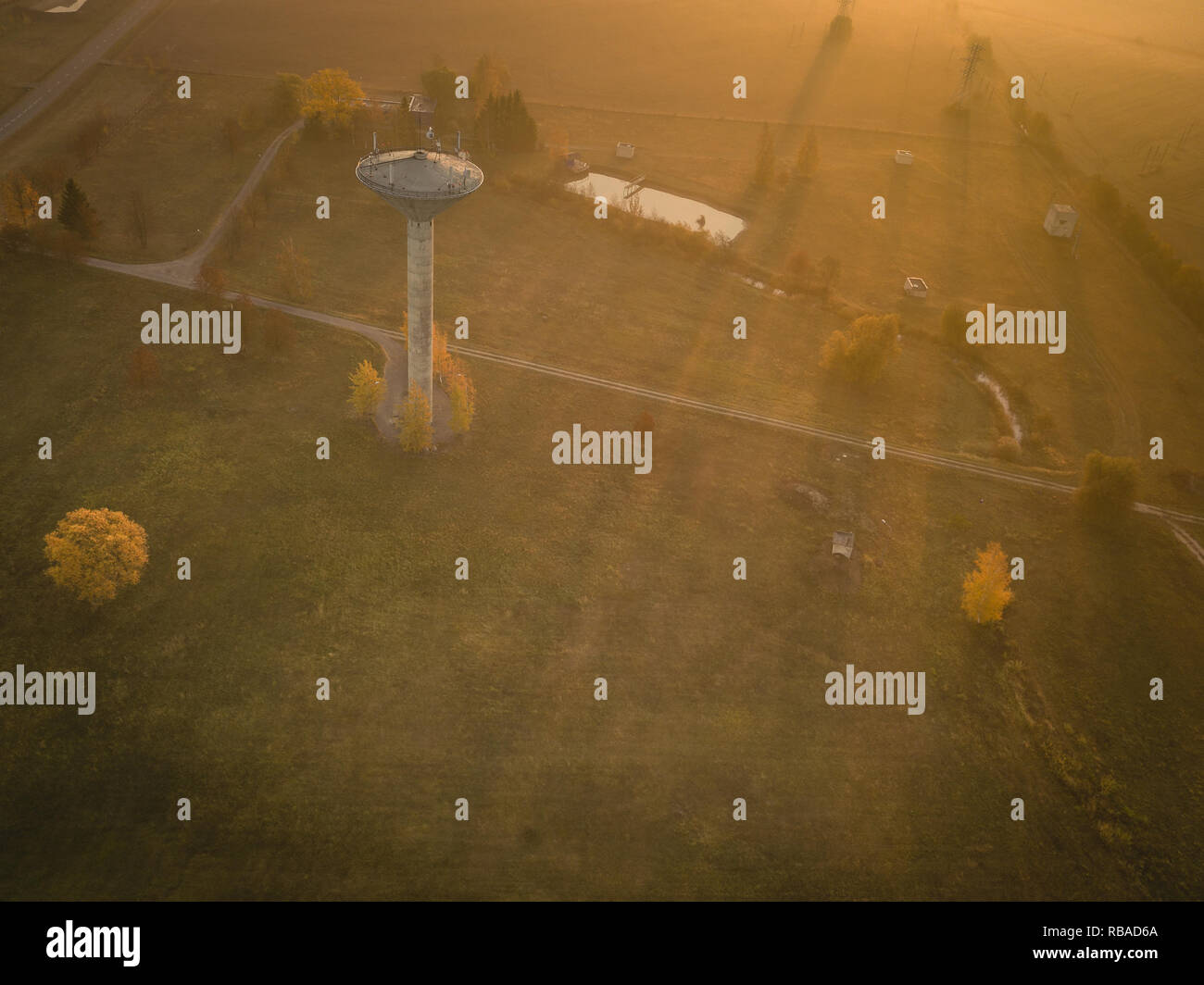 Aerial view of water tower during sunny autumn morning. Stock Photo
