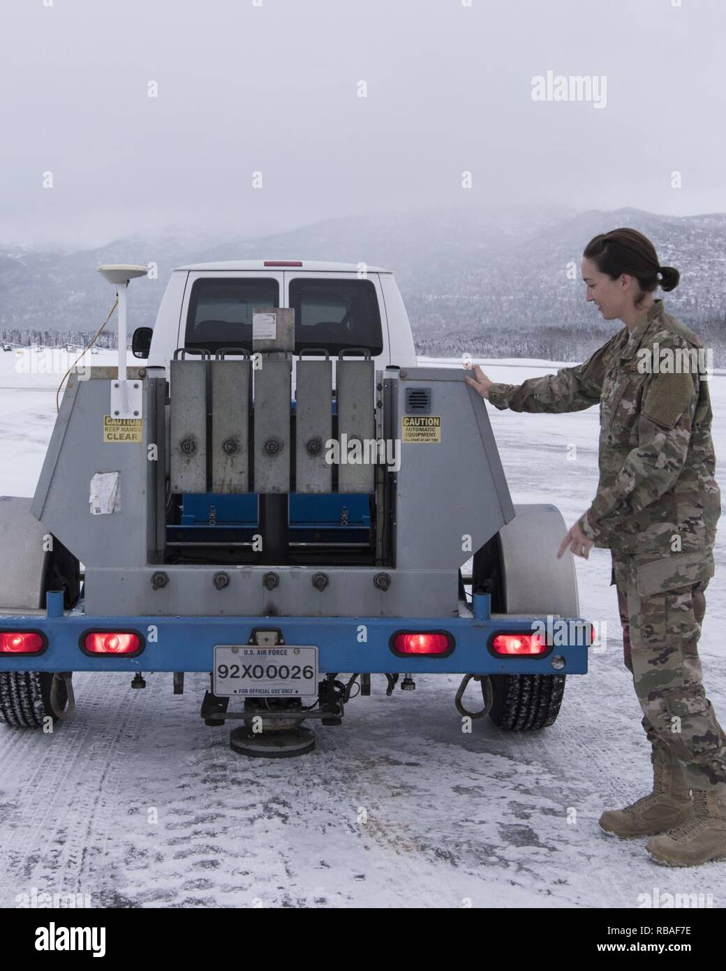 U.S. Air Force Master Sgt. Jill Reed, Air Force Civil Engineer Center's  Airfield Pavement Evaluation Team superintendent, checks a special heavy  falling weight Dynatest deflectometer, during an evaluation of Bryant Army  Airfield