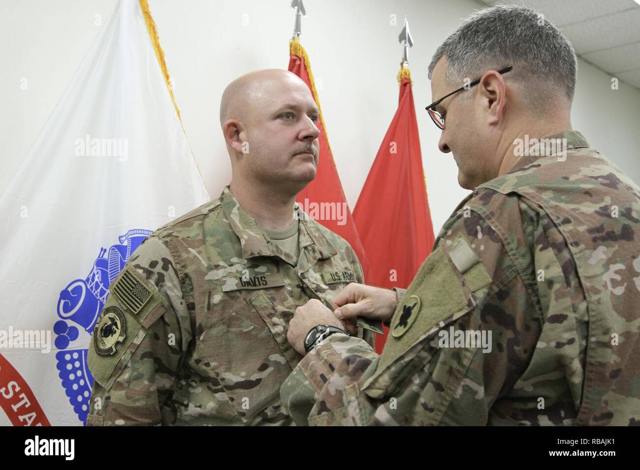 Sean Davis is promoted to the rank of lieutenant colonel at Camp Arifjan, Kuwait, by Brig. Gen. Clint E. Walker, 184th Sustainment Command. Stock Photo