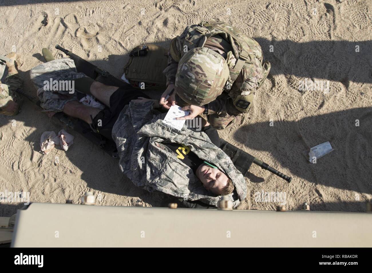 U.S. Army Sgt. Michael B. Drozd, a combat medic assigned to 719th Medical Detachment Veterinary Services, takes notes regarding a simulated casualty during a medical training scenario, Dec. 23, 2018, Camp Arifjan, Kuwait. U.S. Army Central combat medic Soldiers conduct regular training to maintain a high level of combat readiness and proficiency. Stock Photo