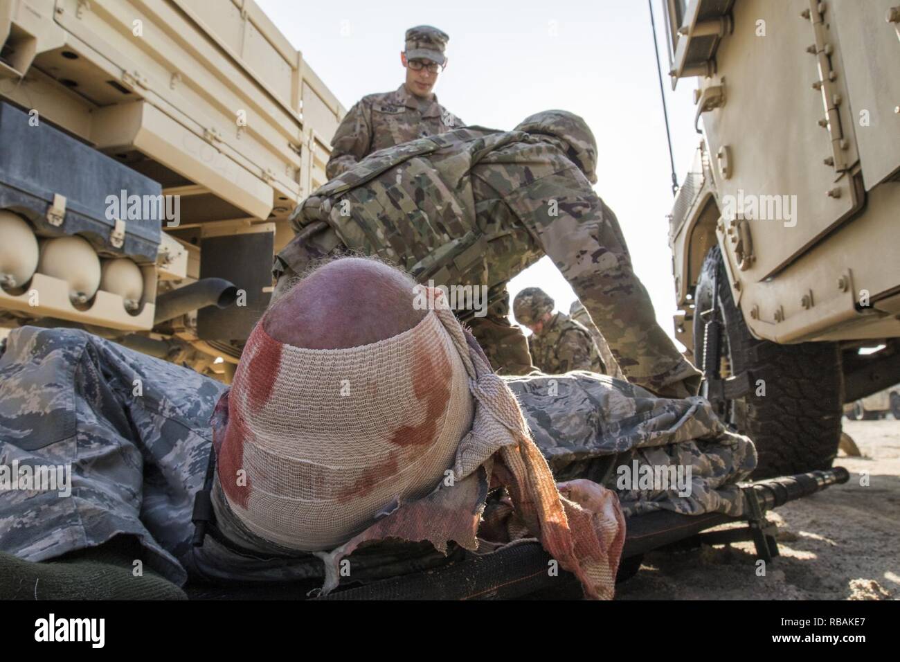 U.S. Army Sgt. Michael B. Drozd, a combat medic assigned to  the 719th Medical Detachment Veterinary Services, treats a simulated casualty during a medical training scenario, Dec. 23, 2018, Camp Arifjan, Kuwait. U.S. Army Central combat medic Soldiers conduct regular training to maintain a high level of combat readiness and proficiency. Stock Photo