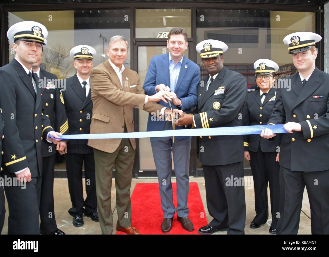 OKLAHOMA CITY (Dec. 27, 2018) Assistant Secretary of the Navy (Manpower and Reserve Affairs), retired Rear Adm. Gregory J. Slovonic, left, Mayor of Oklahoma City, David Holt, center, and Cmdr. Brock Miller, commanding officer Navy Recruiting District Dallas, launch the grand opening of Navy Officer Recruiting Station (NORS) Oklahoma during a ribbon cutting ceremony. NORS Oklahoma is the first and only Navy Officer Recruiting Station in the state and is assigned to Navy Recruiting District (NRD) Dallas. Stock Photo