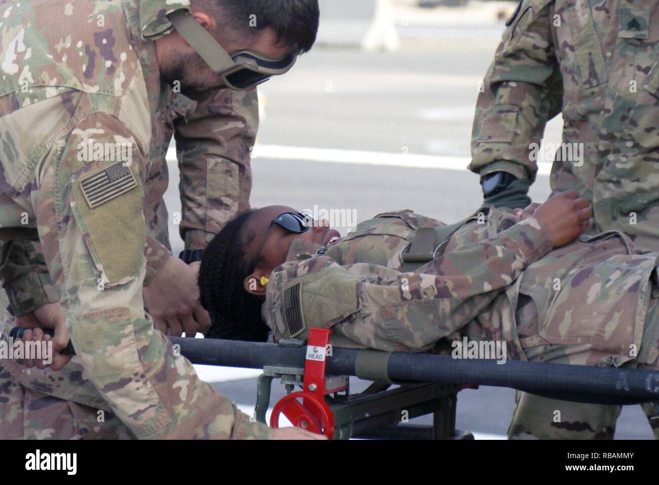 Sgt. Sylvia Mwangi, 452nd Combat Support Hospital, lays on a gurney as a mock casualty during training December 28, 2018, at Camp Arifjan, Kuwait. Stock Photo