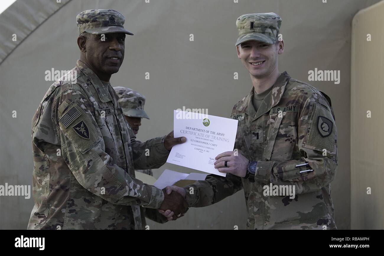 1st Lt. Christopher Carty accepts his graduation certificate from