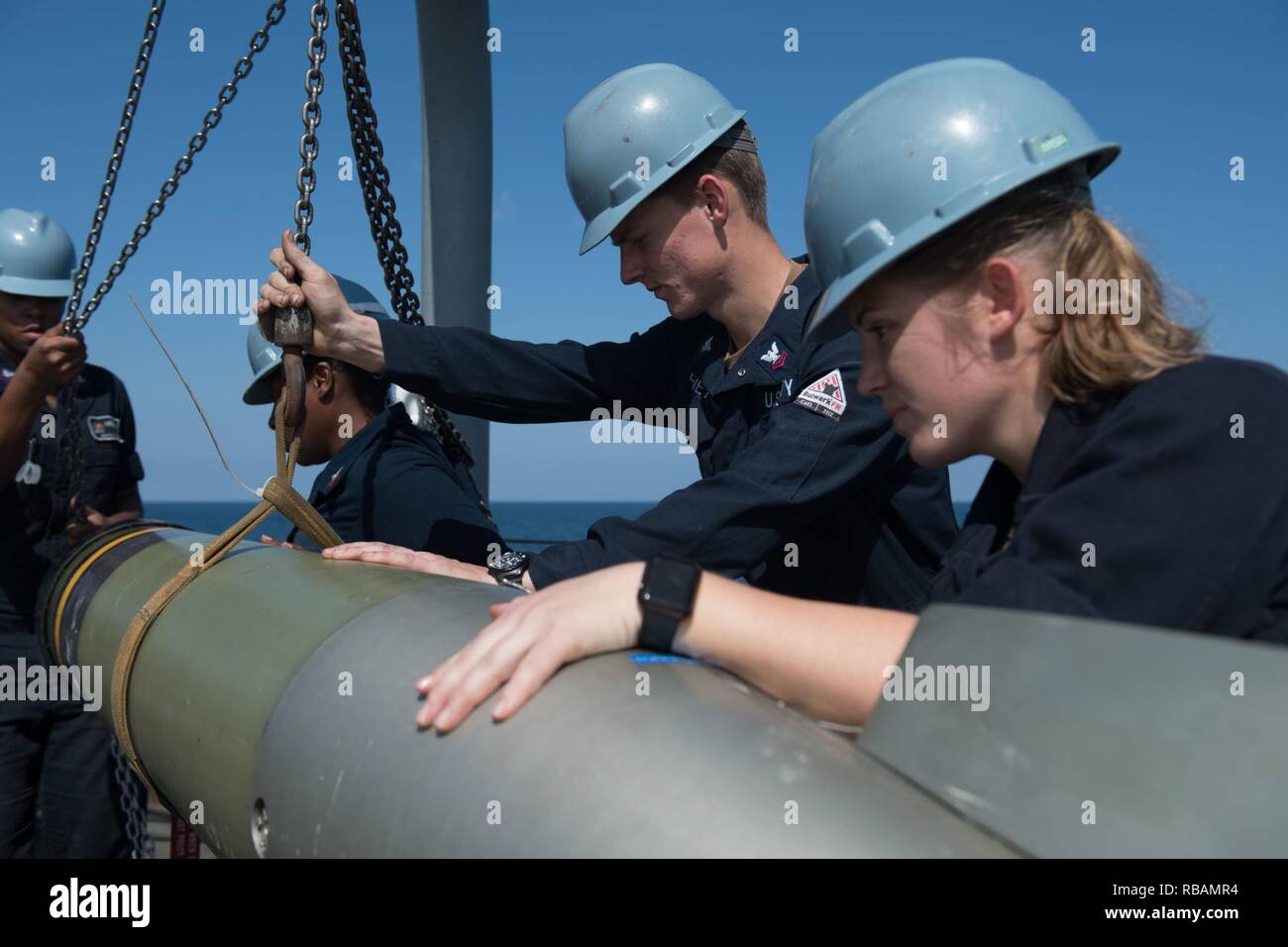 U.S. Sailors handle a Mark 46 torpedo aboard the guided-missile ...