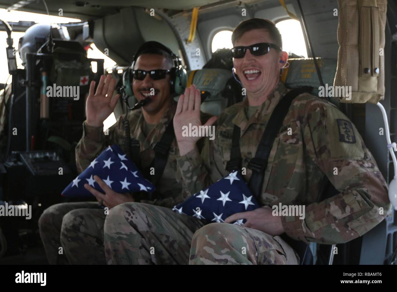 Spc. Aaron Clayborn and Sgt. Jesse Adams, 452nd Combat Support Hospital, re-enlist while flying in a UH-60 Black Hawk at Camp Arifjan, Kuwait. Stock Photo