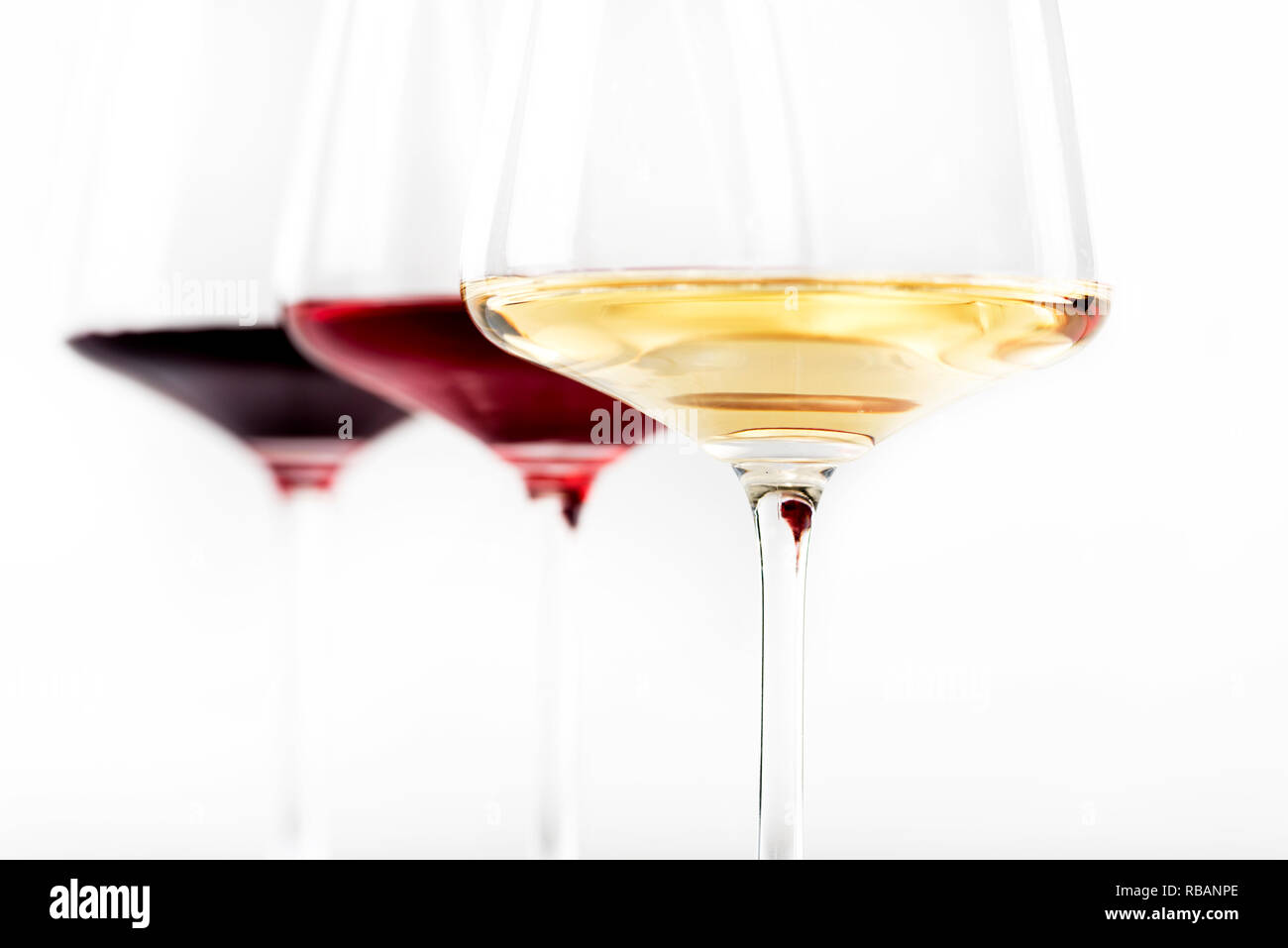 Three Glass Of Red Rose And White Wine Isolated Over White